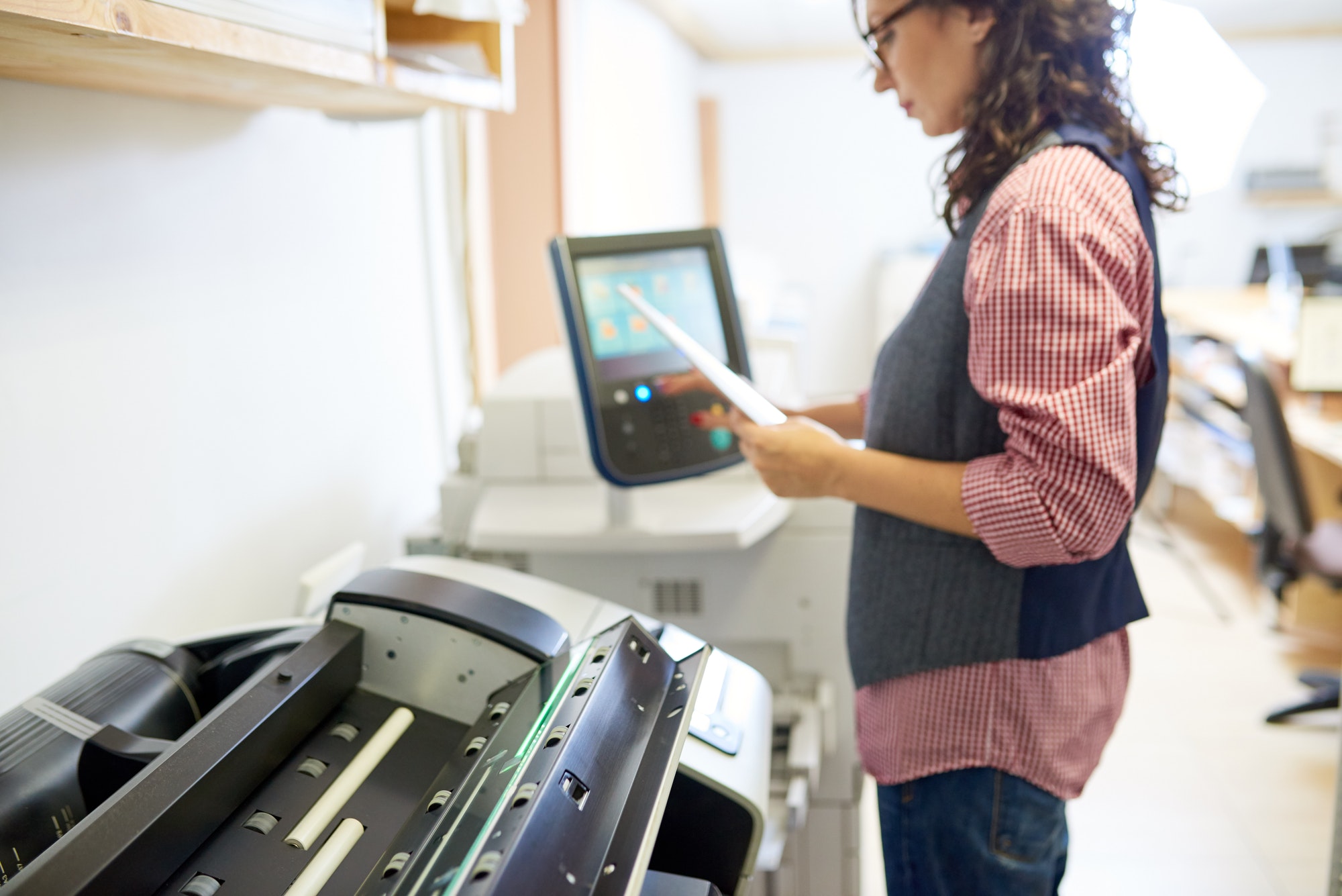 Woman adjusting settings on printer